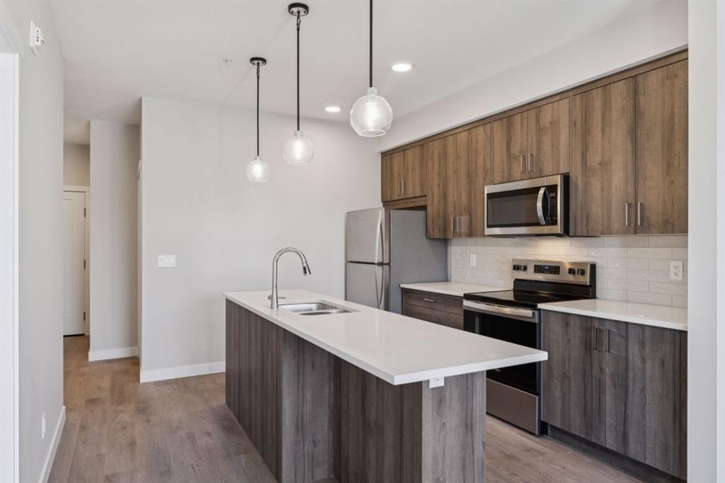 412-700 Shawnee Square Sw, Calgary, AB - Indoor Photo Showing Kitchen With Stainless Steel Kitchen With Double Sink With Upgraded Kitchen