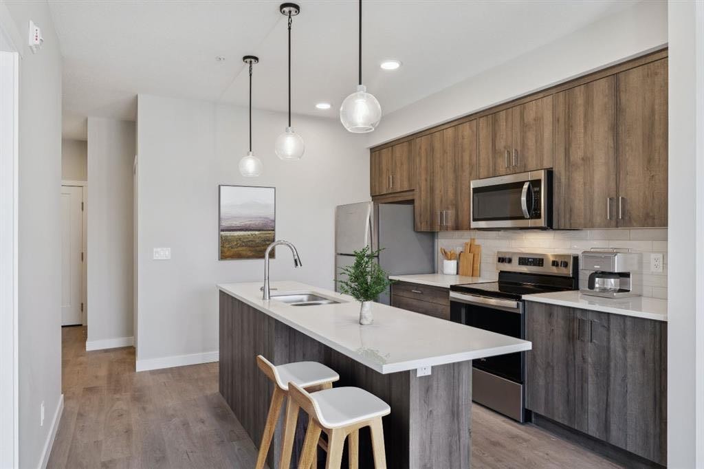 412-700 Shawnee Square Sw, Calgary, AB - Indoor Photo Showing Kitchen With Stainless Steel Kitchen With Double Sink With Upgraded Kitchen