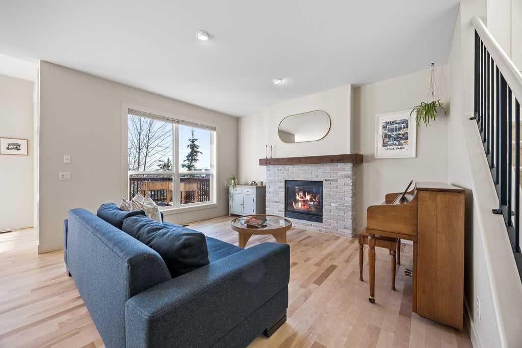 59 Cortina Way Sw, Calgary, AB - Indoor Photo Showing Living Room With Fireplace