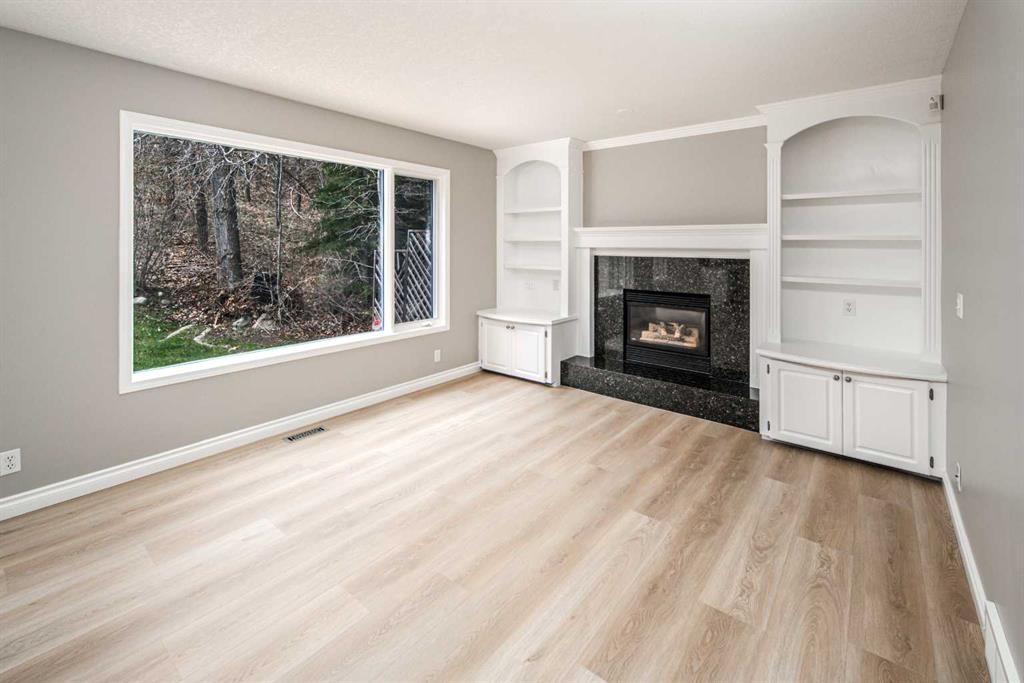 79 Hamptons Heights Nw, Calgary, AB - Indoor Photo Showing Living Room With Fireplace