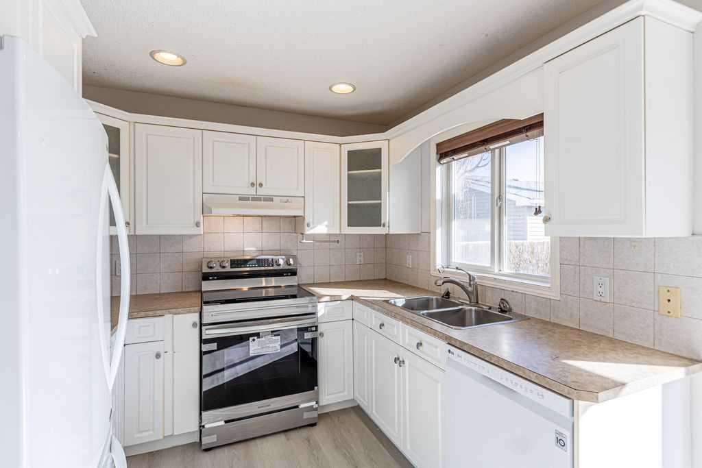 13 Coville Gardens Ne, Calgary, AB - Indoor Photo Showing Kitchen With Double Sink