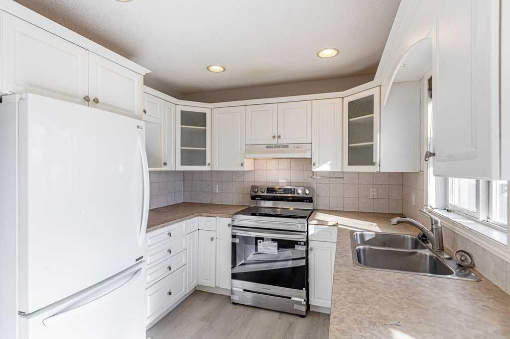 13 Coville Gardens Ne, Calgary, AB - Indoor Photo Showing Kitchen With Double Sink