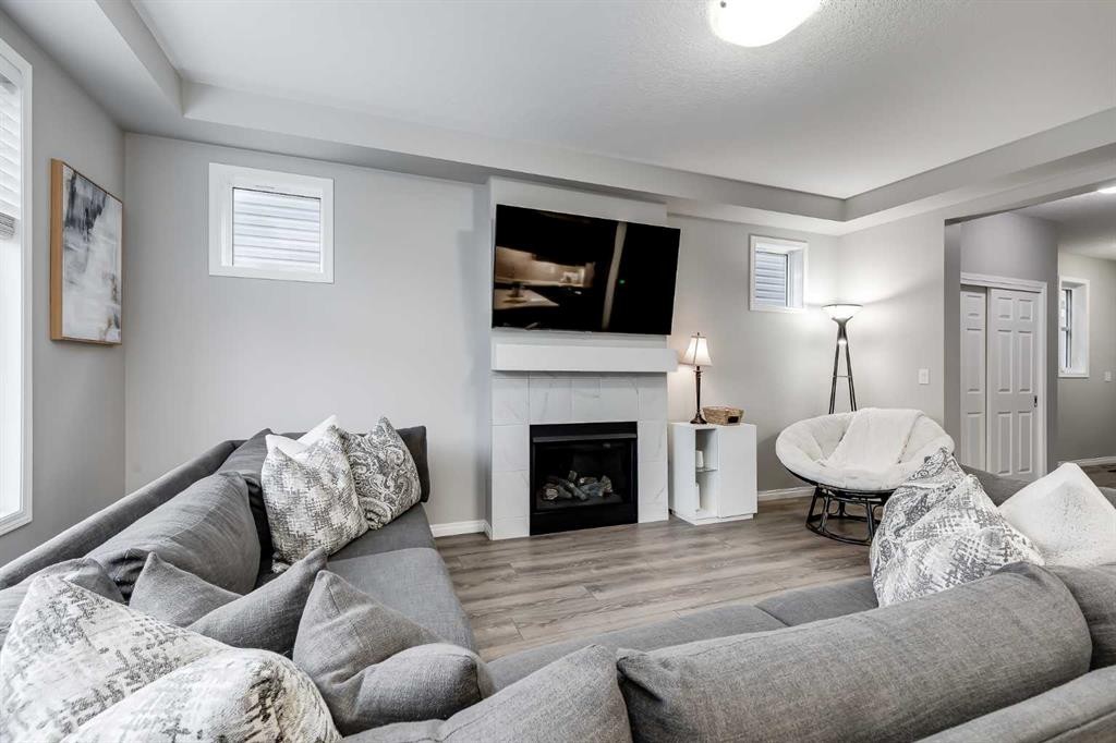 22 Osborne Common Sw, Airdrie, AB - Indoor Photo Showing Living Room With Fireplace