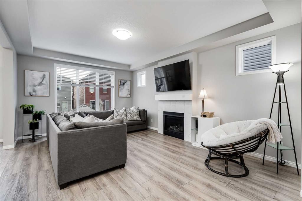 22 Osborne Common Sw, Airdrie, AB - Indoor Photo Showing Living Room With Fireplace