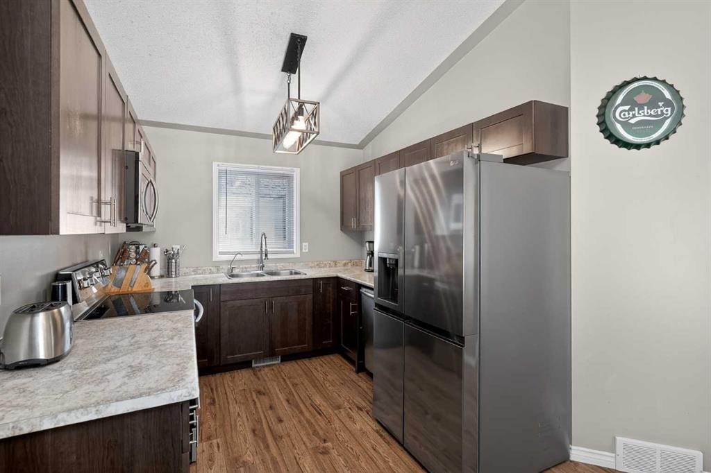 107 Mt Allan Circle Se, Calgary, AB - Indoor Photo Showing Kitchen With Double Sink