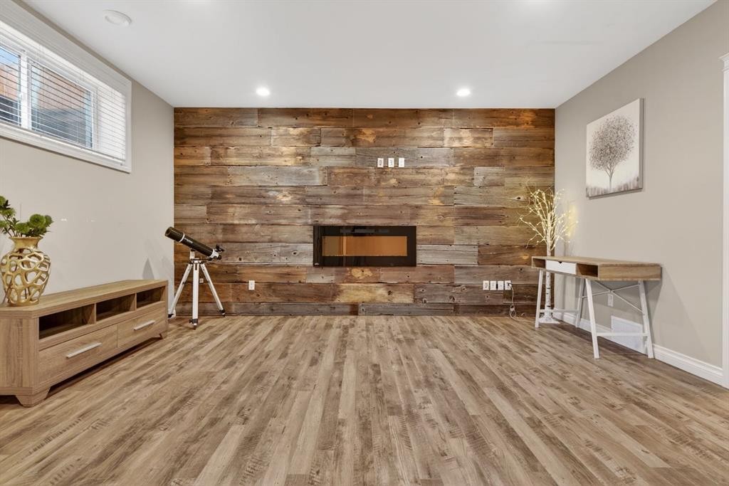 208 Cimarron Drive, Okotoks, AB - Indoor Photo Showing Other Room With Fireplace
