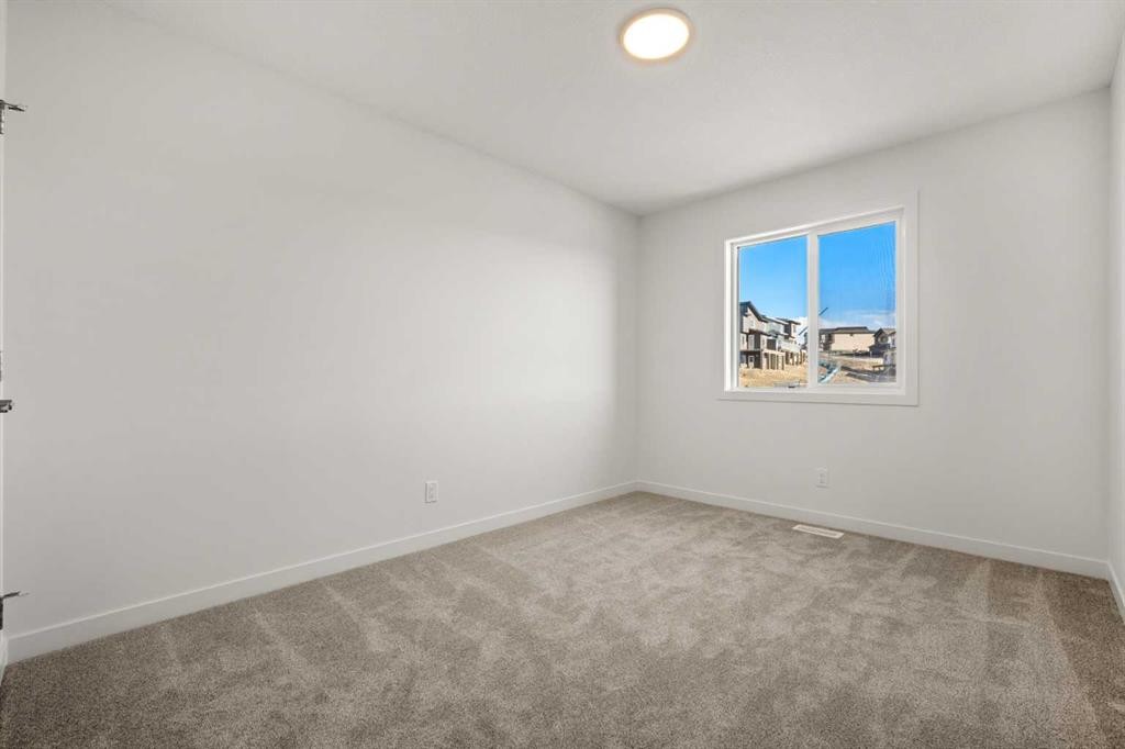 31 Heritage Heath, Cochrane, AB - Indoor Photo Showing Other Room