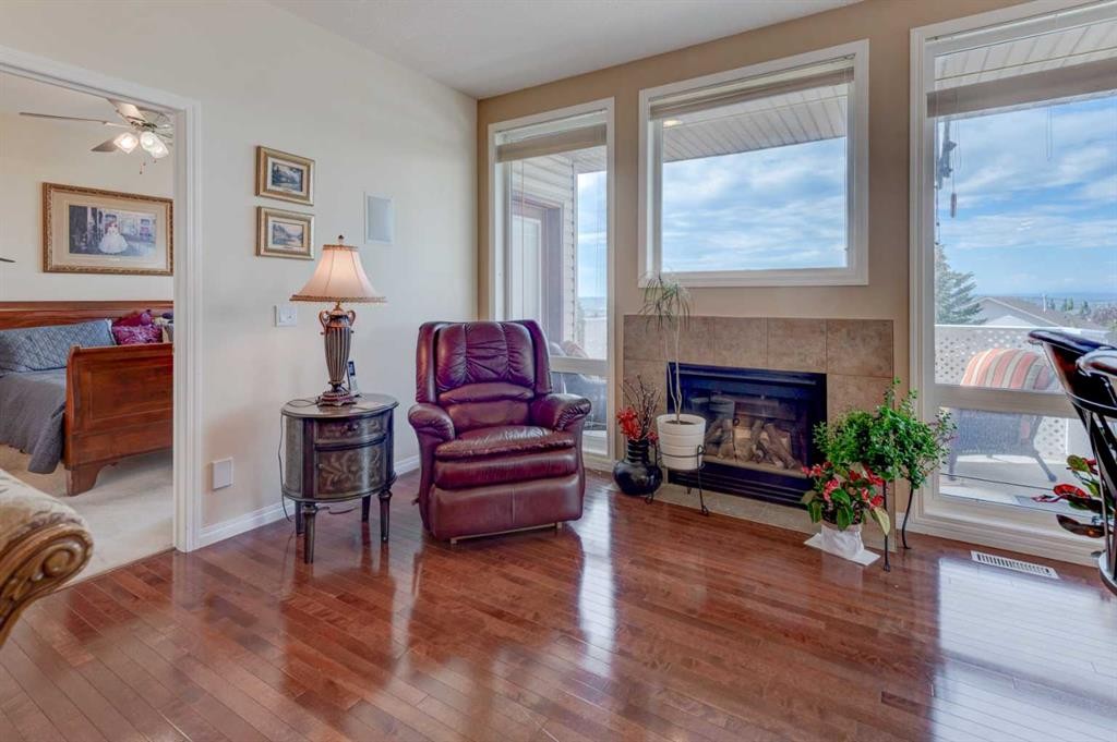49 Arbour Crest Heights Nw, Calgary, AB - Indoor Photo Showing Living Room With Fireplace