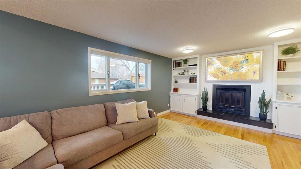 84 Sunmount Road Se, Calgary, AB - Indoor Photo Showing Living Room With Fireplace