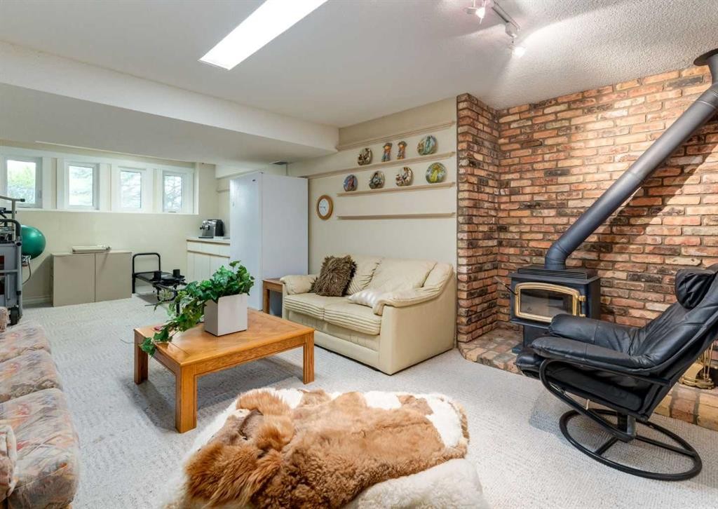 164 Hawksbrow Drive Nw, Calgary, AB - Indoor Photo Showing Living Room With Fireplace