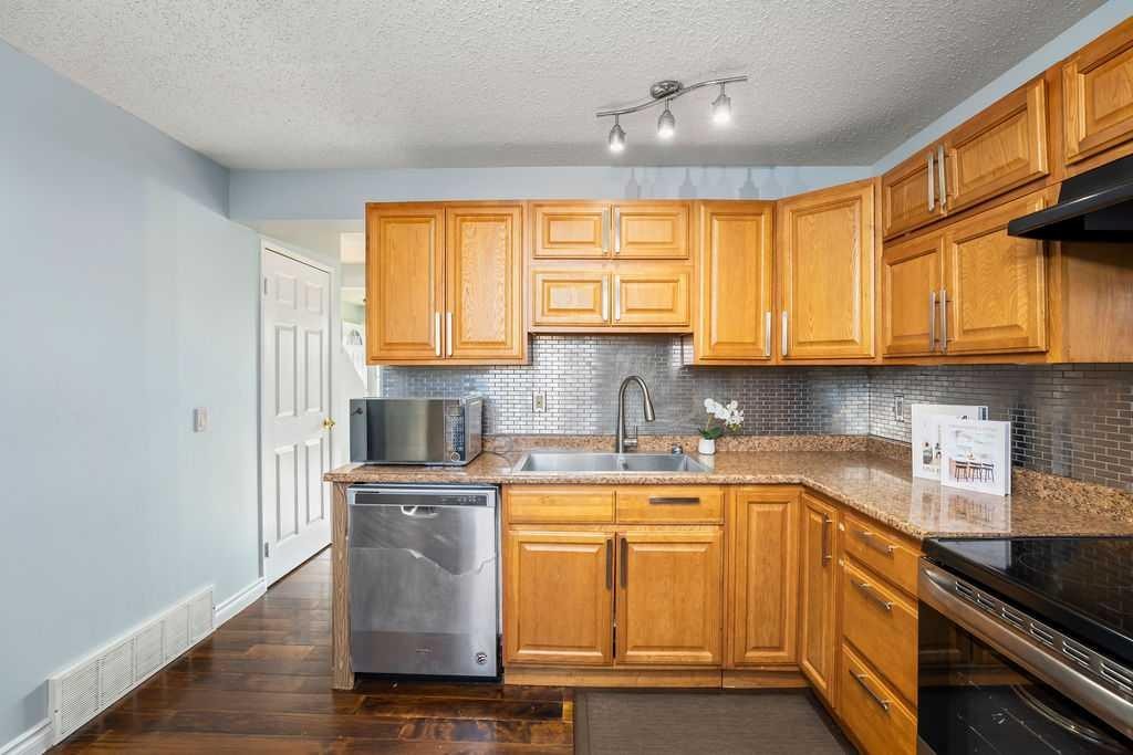74 Castledale Way Ne, Calgary, AB - Indoor Photo Showing Kitchen With Double Sink