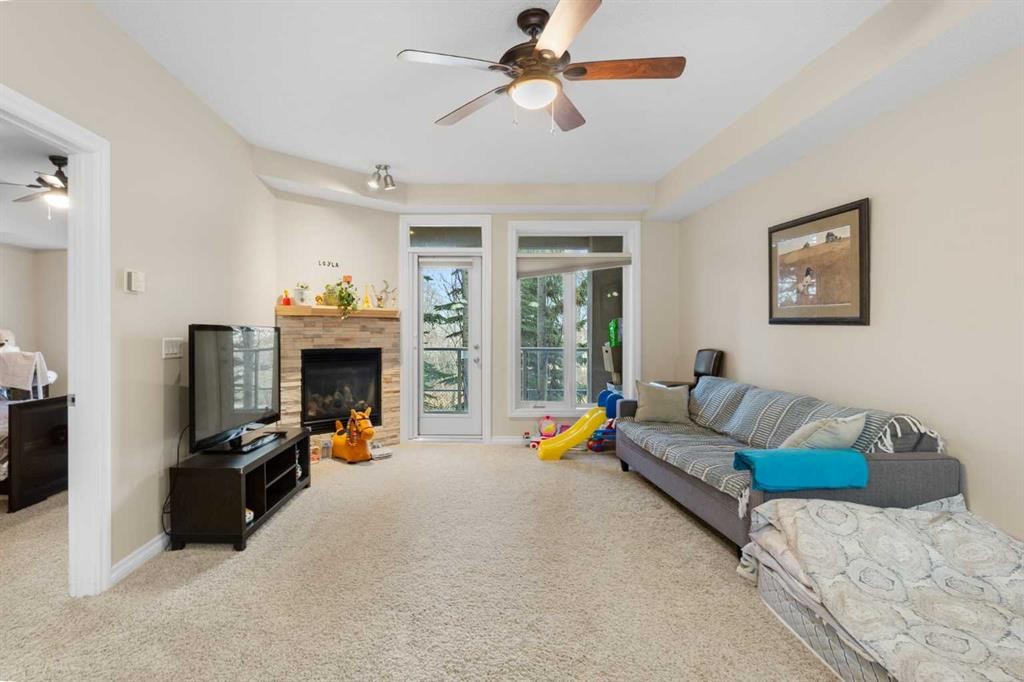 8103-14 Hemlock Crescent Sw, Calgary, AB - Indoor Photo Showing Living Room With Fireplace