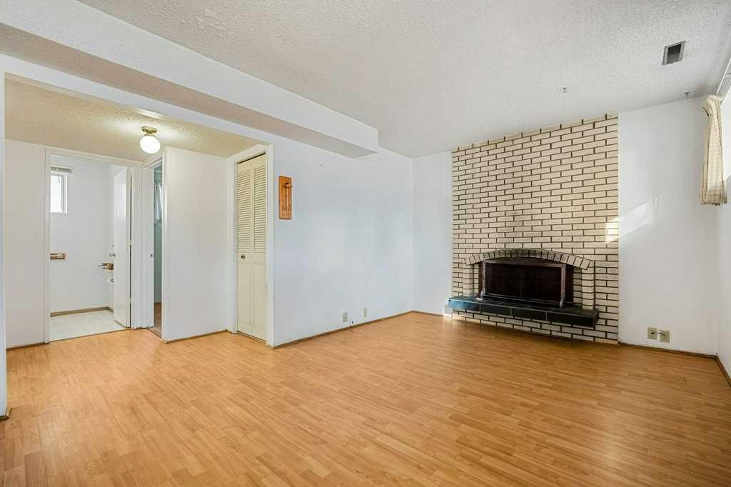 5813 Dalcastle Crescent Nw, Calgary, AB - Indoor Photo Showing Living Room With Fireplace