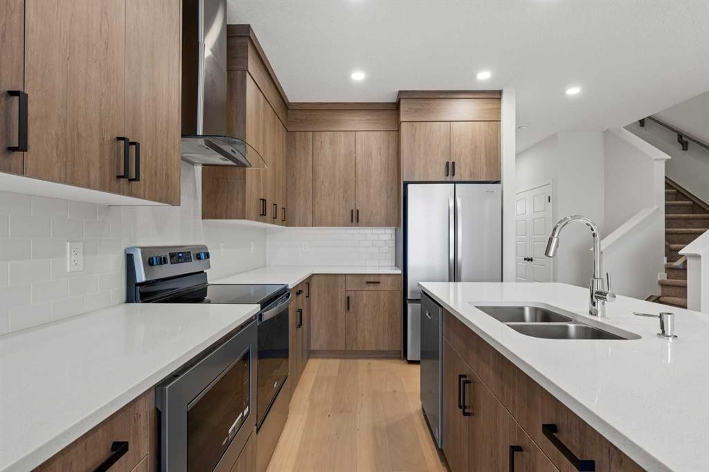 117 Bridgeport Gate, Chestermere, AB - Indoor Photo Showing Kitchen With Double Sink With Upgraded Kitchen