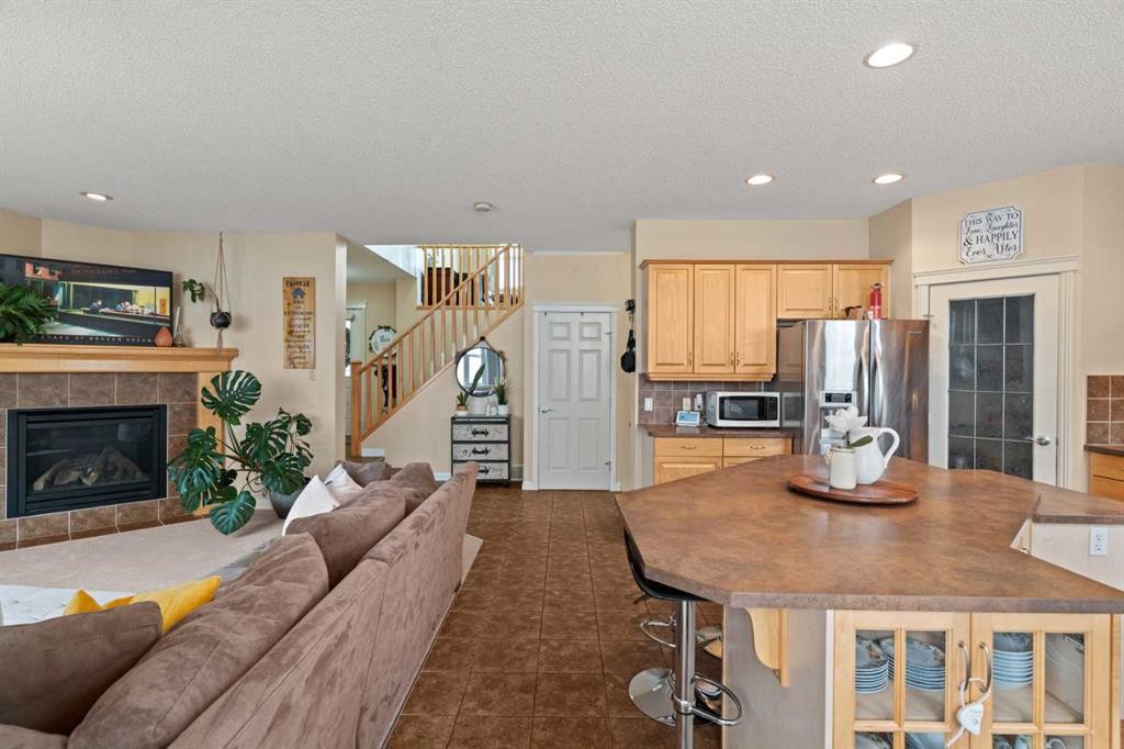 137 Copperleaf Bay Se, Calgary, AB - Indoor Photo Showing Other Room With Fireplace