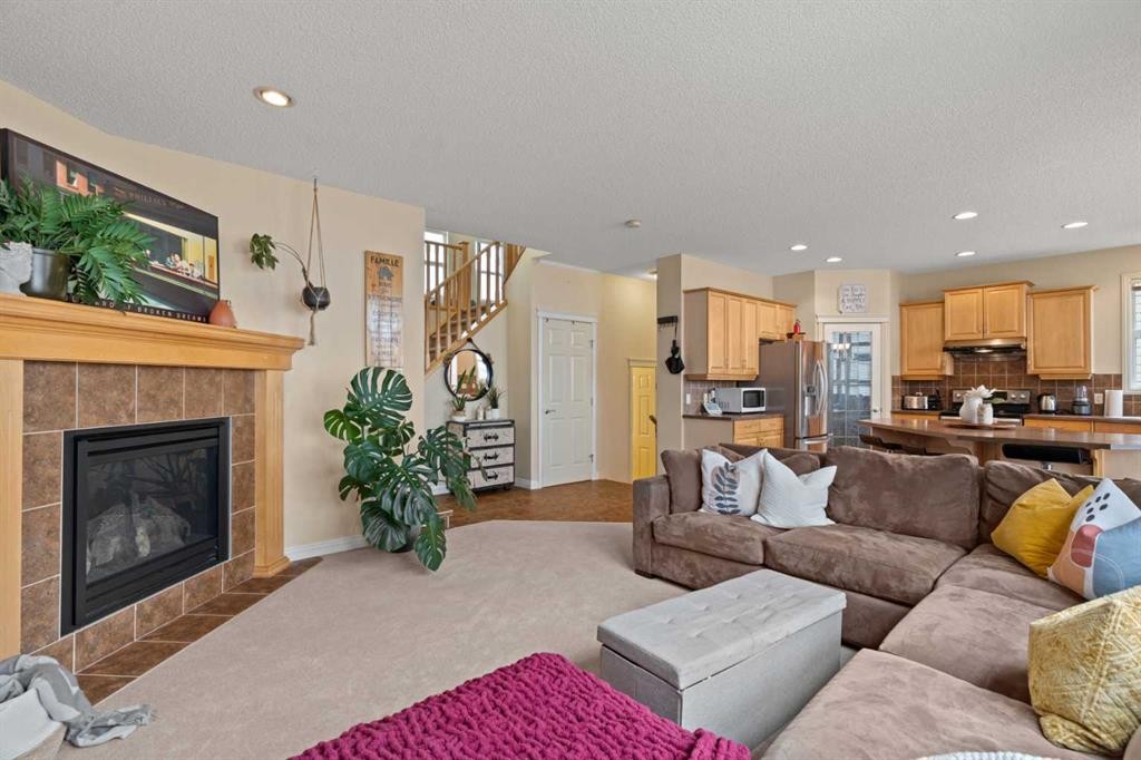 137 Copperleaf Bay Se, Calgary, AB - Indoor Photo Showing Living Room With Fireplace