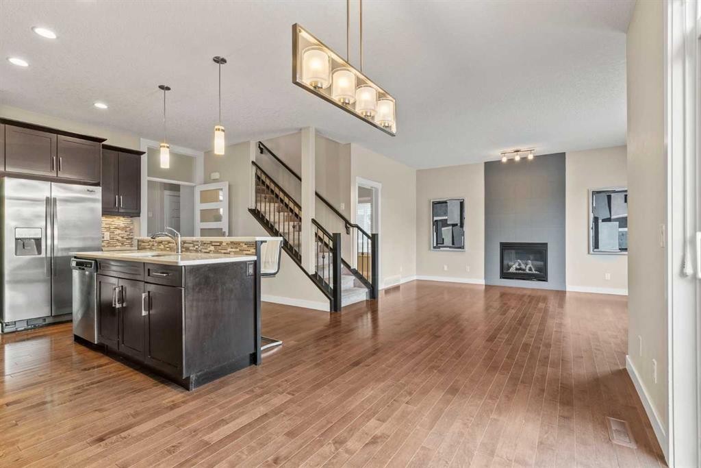 2306 Bayside Circle Sw, Airdrie, AB - Indoor Photo Showing Kitchen With Fireplace With Upgraded Kitchen