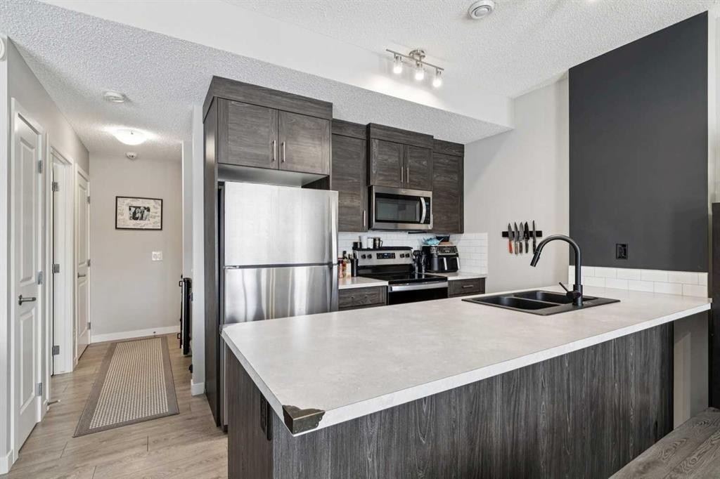 1009-250 Fireside View, Cochrane, AB - Indoor Photo Showing Kitchen With Stainless Steel Kitchen With Double Sink With Upgraded Kitchen