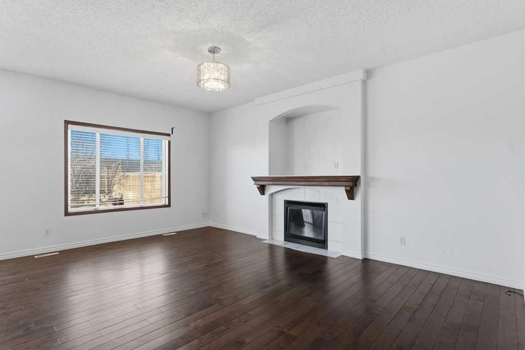 106 New Brighton Circle Se, Calgary, AB - Indoor Photo Showing Living Room With Fireplace