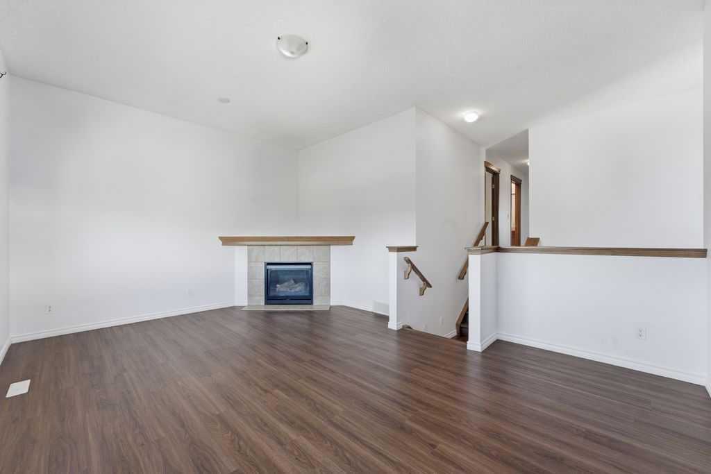 106 New Brighton Circle Se, Calgary, AB - Indoor Photo Showing Other Room With Fireplace