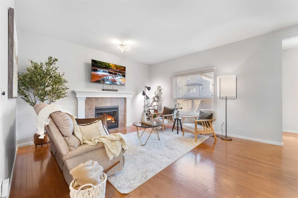295 Prairie Springs Crescent Sw, Airdrie, AB - Indoor Photo Showing Living Room With Fireplace