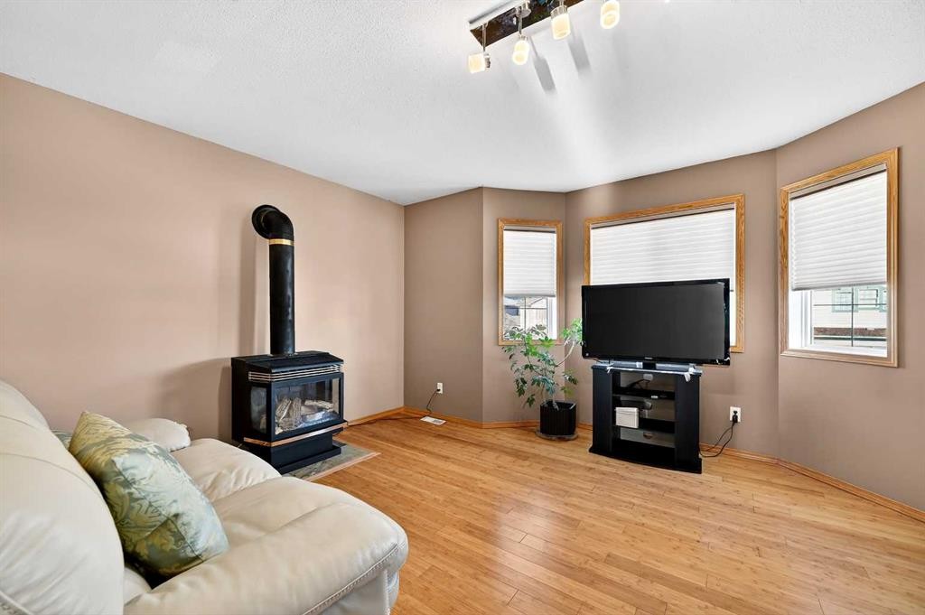 30 Tuscarora Way Nw, Calgary, AB - Indoor Photo Showing Living Room With Fireplace