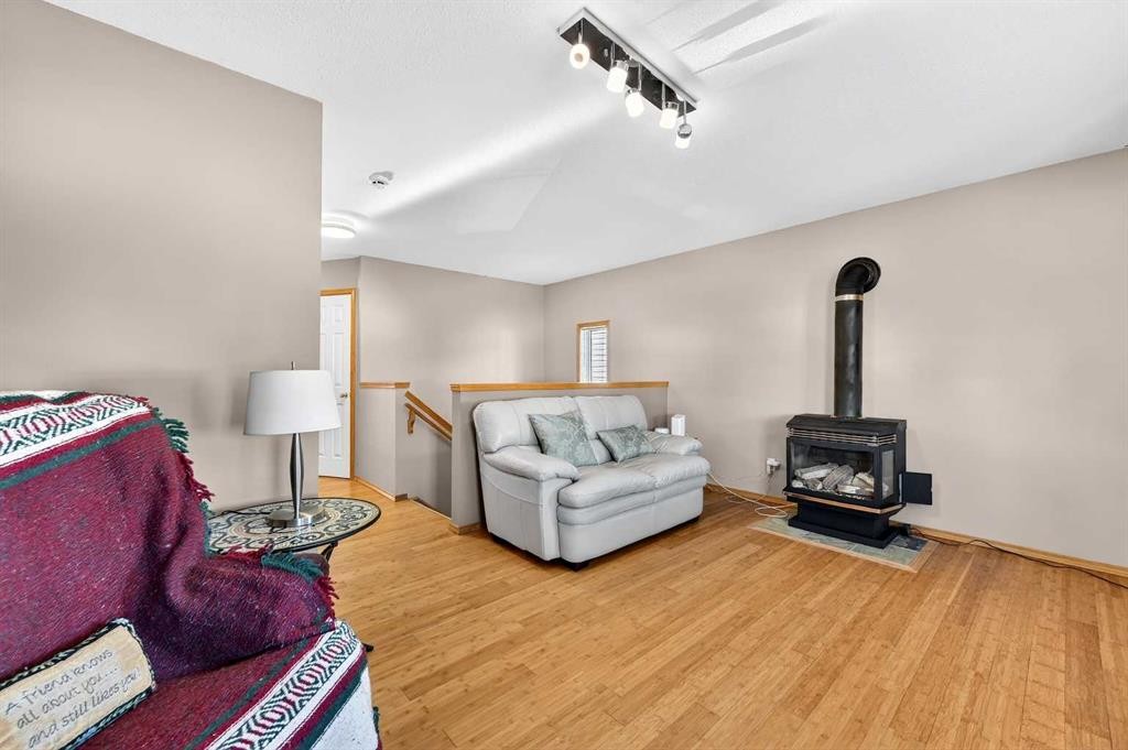 30 Tuscarora Way Nw, Calgary, AB - Indoor Photo Showing Other Room With Fireplace