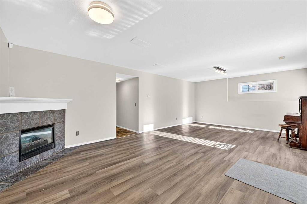 30 Tuscarora Way Nw, Calgary, AB - Indoor Photo Showing Living Room With Fireplace