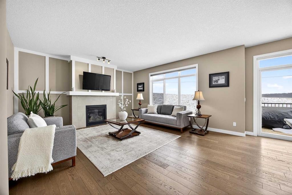 144 Sundown View, Cochrane, AB - Indoor Photo Showing Living Room With Fireplace