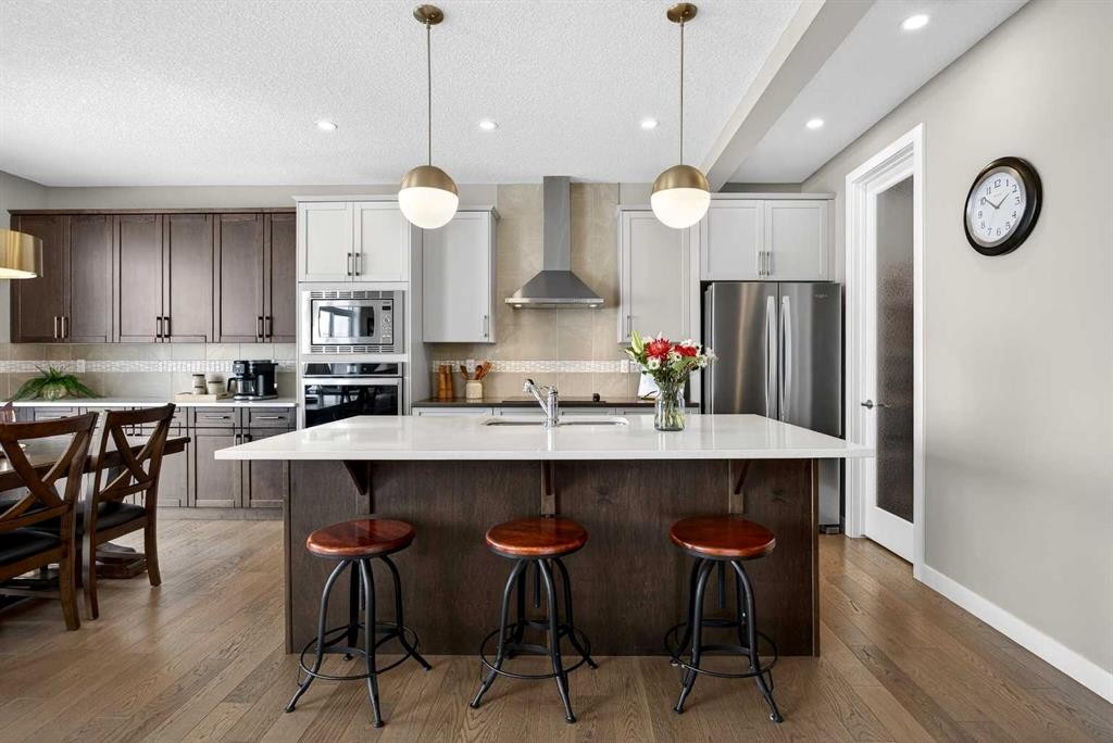 144 Sundown View, Cochrane, AB - Indoor Photo Showing Kitchen With Stainless Steel Kitchen With Upgraded Kitchen