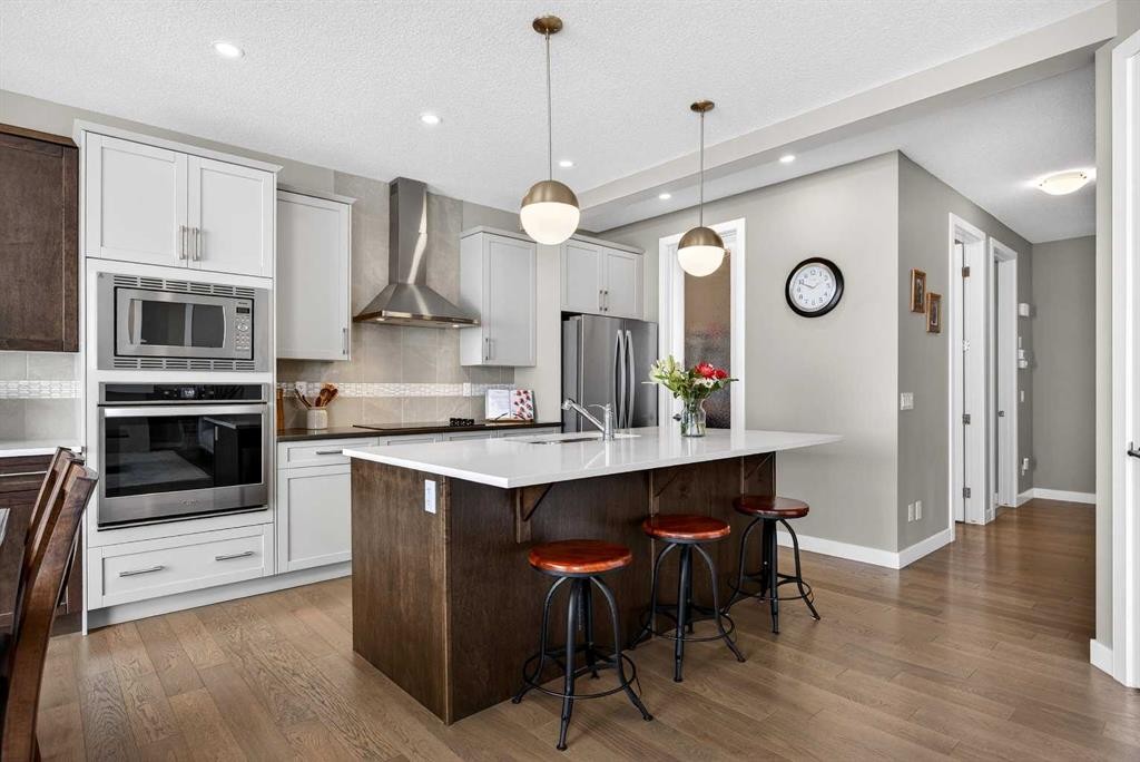 144 Sundown View, Cochrane, AB - Indoor Photo Showing Kitchen With Stainless Steel Kitchen With Upgraded Kitchen