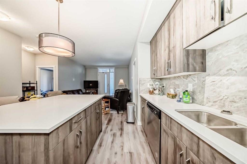 108-71 Shawnee Common Sw, Calgary, AB - Indoor Photo Showing Kitchen With Double Sink