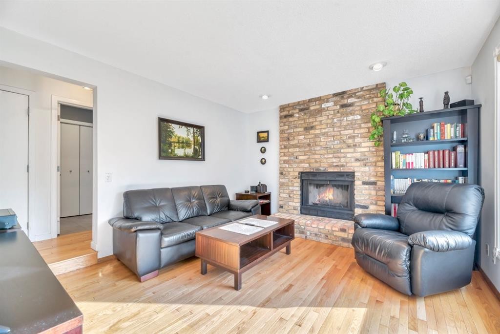 323 Hawkwood Boulevard Nw, Calgary, AB - Indoor Photo Showing Living Room With Fireplace