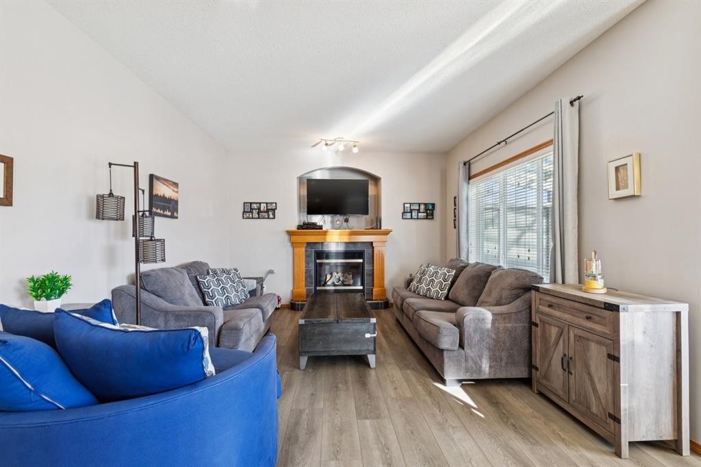 2841 Coopers Manor Sw, Airdrie, AB - Indoor Photo Showing Living Room With Fireplace