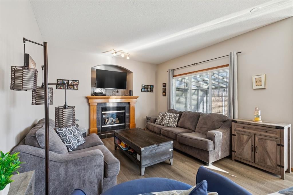 2841 Coopers Manor Sw, Airdrie, AB - Indoor Photo Showing Living Room With Fireplace