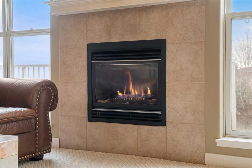 702 Patterson View Sw, Calgary, AB - Indoor Photo Showing Living Room With Fireplace