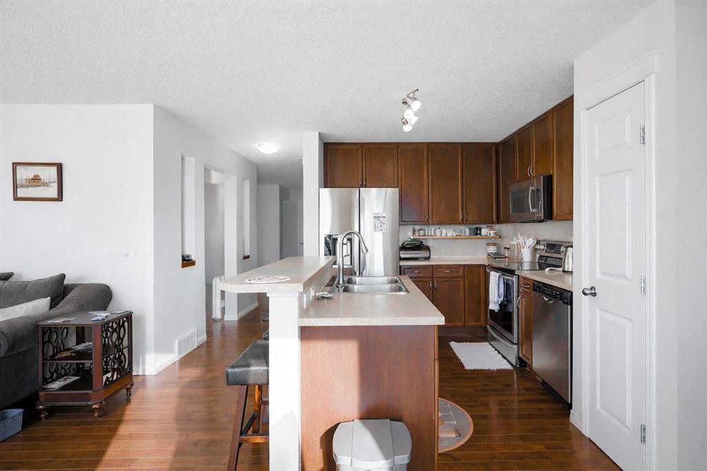 125 Silverado Range Cove Sw, Calgary, AB - Indoor Photo Showing Kitchen With Stainless Steel Kitchen With Double Sink