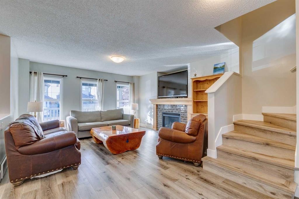 199 Everglen Way Sw, Calgary, AB - Indoor Photo Showing Living Room With Fireplace