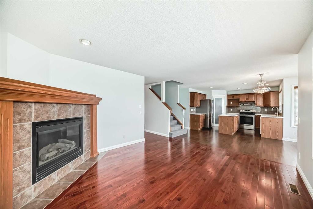 234 Panatella Boulevard Nw, Calgary, AB - Indoor Photo Showing Living Room With Fireplace