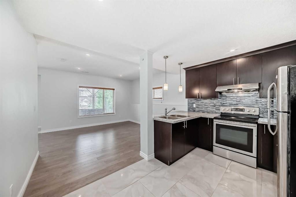 234 Panatella Boulevard Nw, Calgary, AB - Indoor Photo Showing Kitchen With Double Sink With Upgraded Kitchen