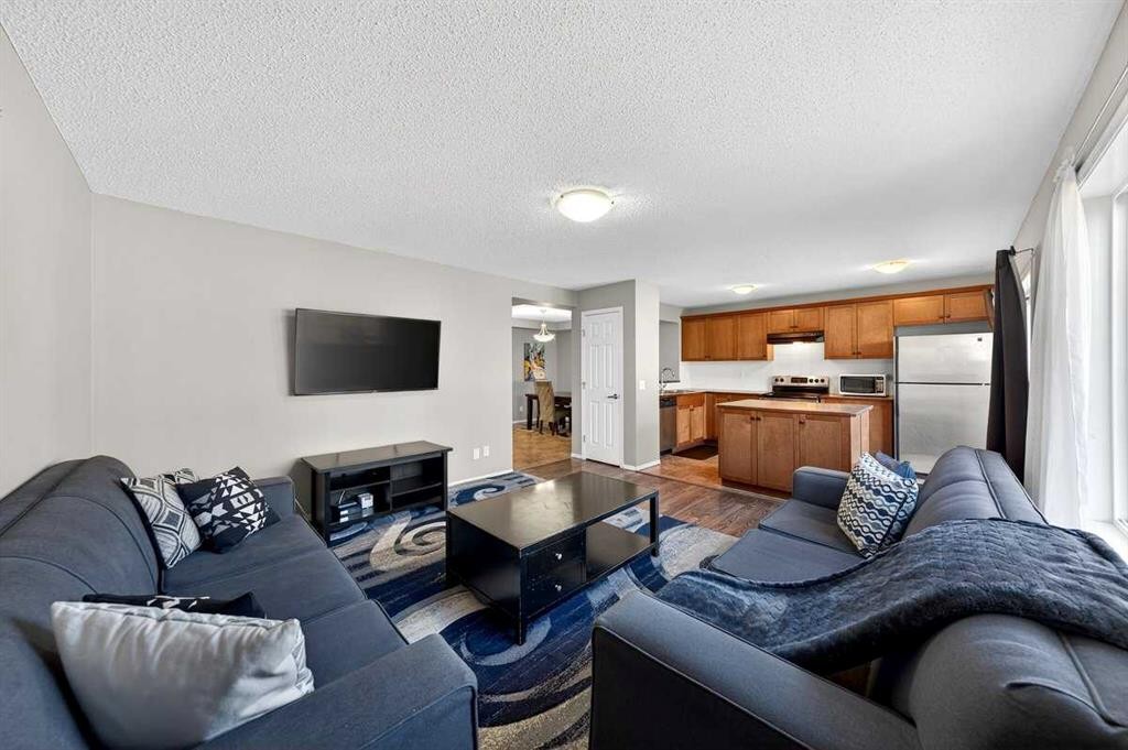 899 Windhaven Close Sw, Airdrie, AB - Indoor Photo Showing Living Room With Fireplace