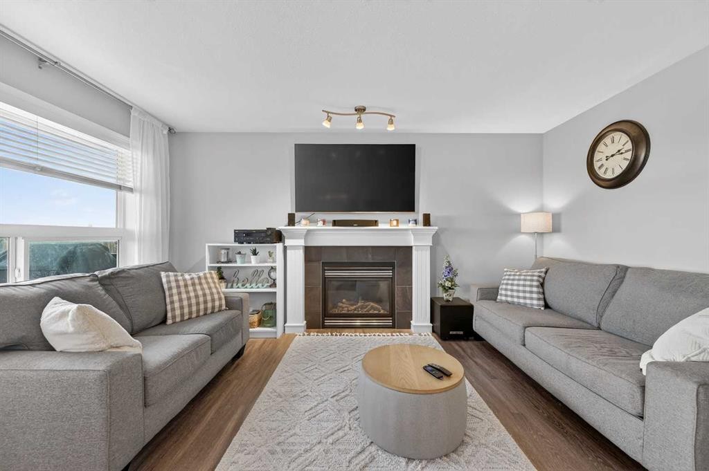 201 Saddlecrest Way Ne, Calgary, AB - Indoor Photo Showing Living Room With Fireplace