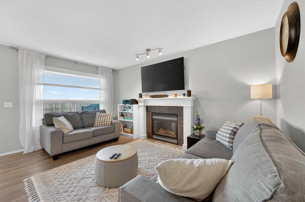 201 Saddlecrest Way Ne, Calgary, AB - Indoor Photo Showing Living Room With Fireplace