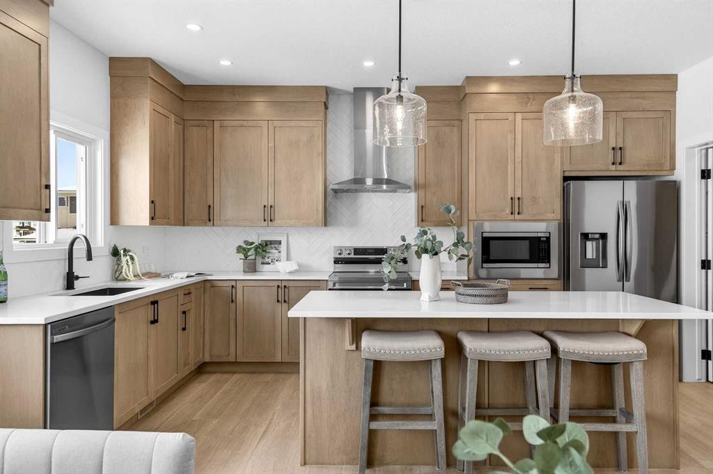 52 Fireside Common Sw, Cochrane, AB - Indoor Photo Showing Kitchen With Upgraded Kitchen