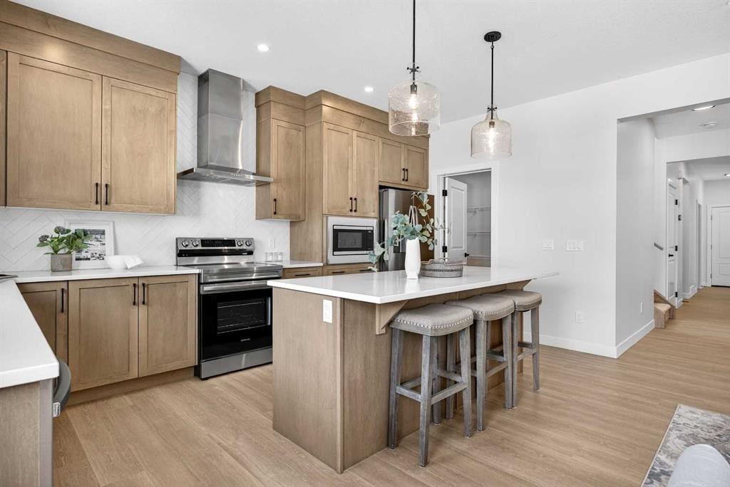52 Fireside Common Sw, Cochrane, AB - Indoor Photo Showing Kitchen With Upgraded Kitchen