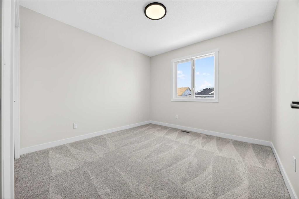 52 Fireside Common Sw, Cochrane, AB - Indoor Photo Showing Other Room