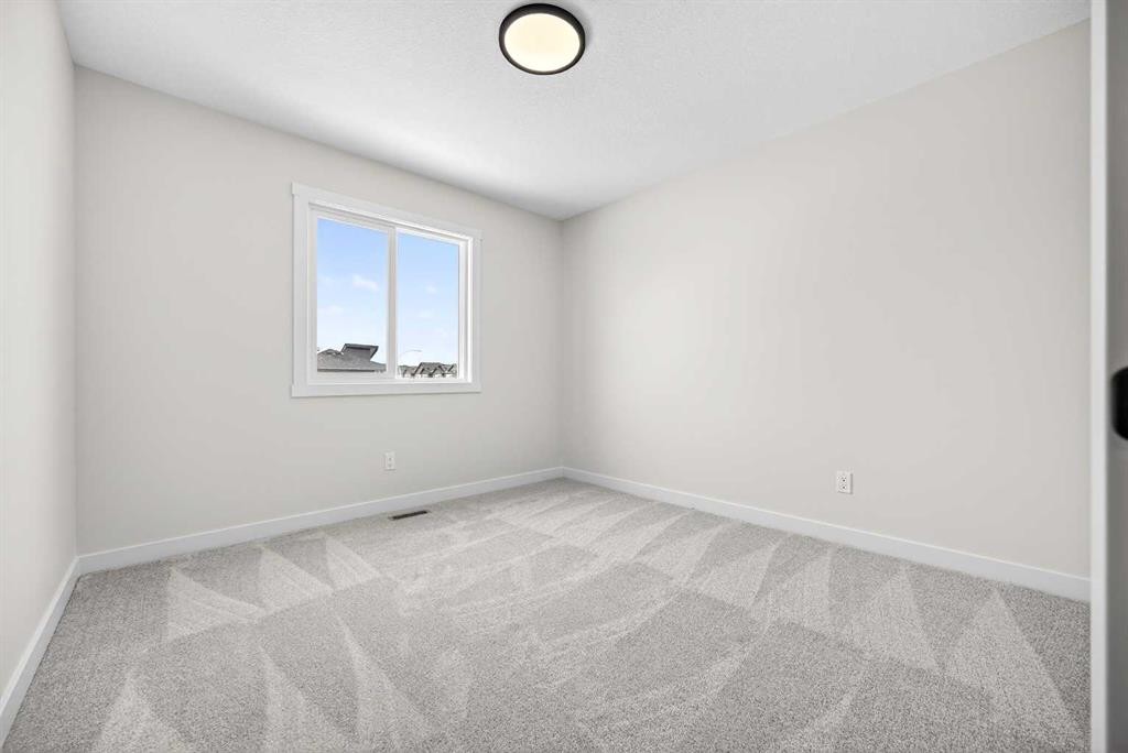 52 Fireside Common Sw, Cochrane, AB - Indoor Photo Showing Other Room