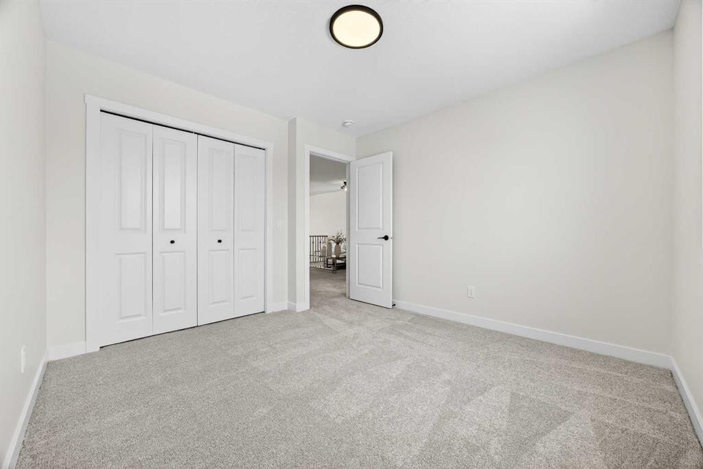 52 Fireside Common Sw, Cochrane, AB - Indoor Photo Showing Other Room