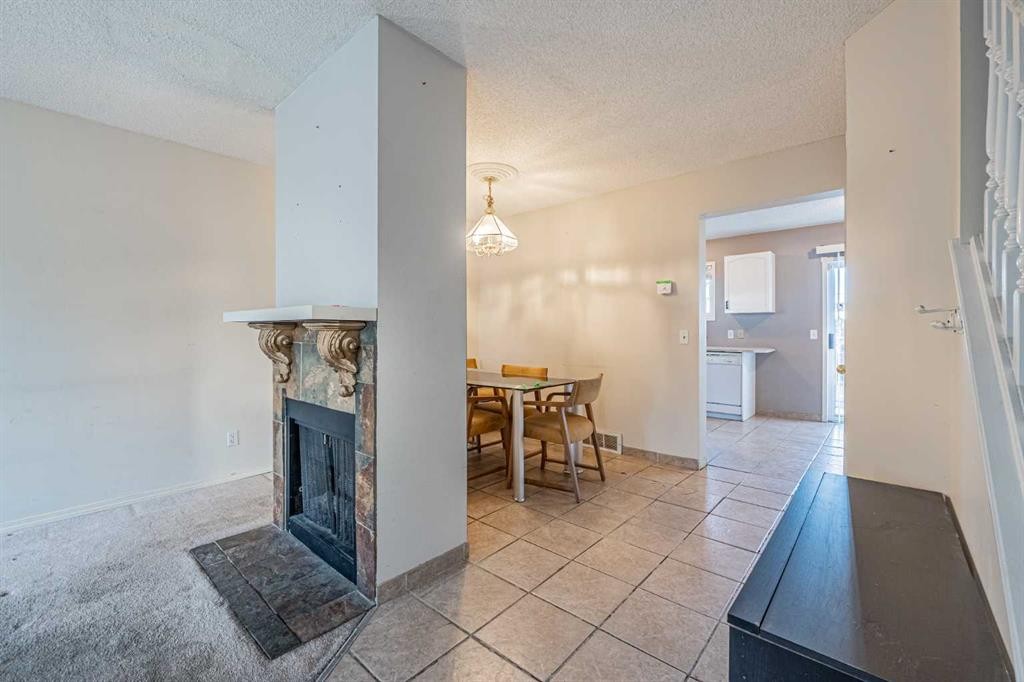 68 Abbeydale Villas Ne, Calgary, AB - Indoor Photo Showing Other Room With Fireplace