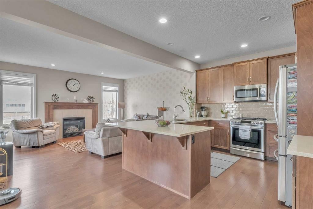 145 Walden Park Se, Calgary, AB - Indoor Photo Showing Kitchen With Fireplace With Upgraded Kitchen